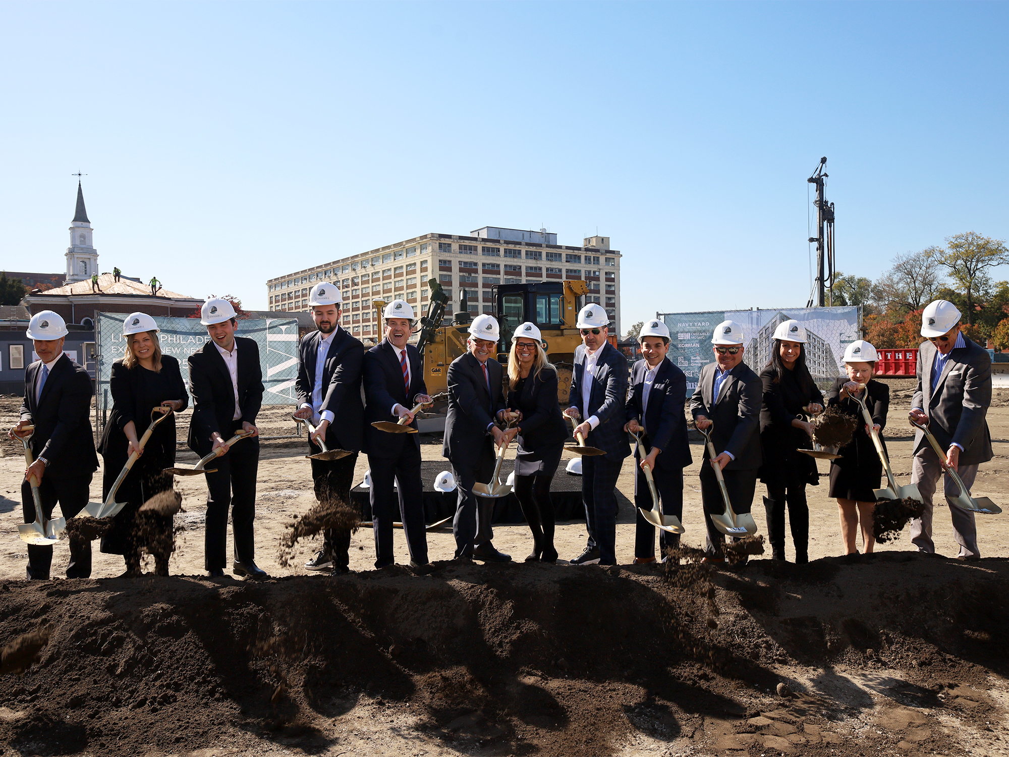 AVE Navy Yard Team Groundbreaking with shovels and cityscape in background