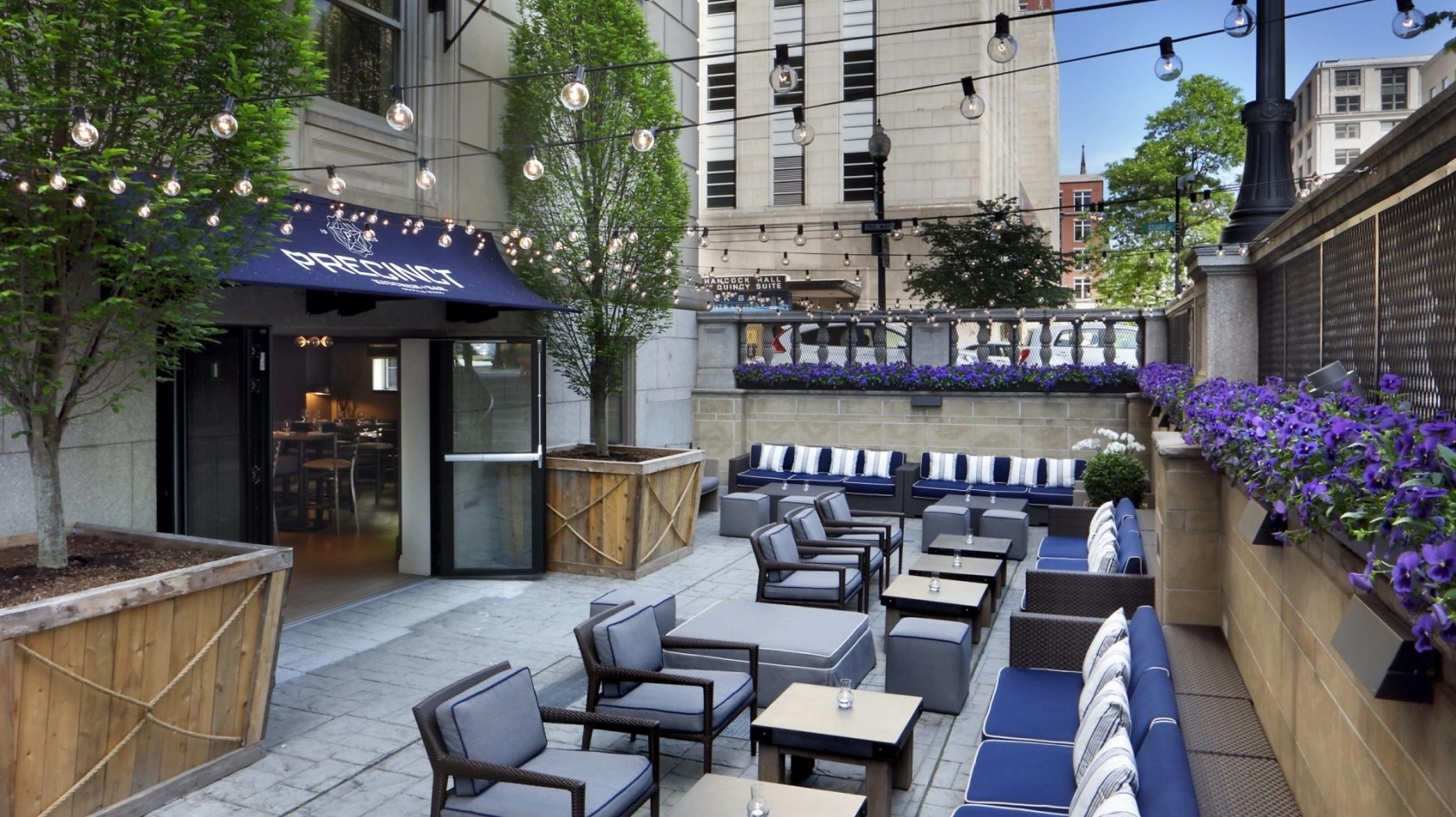 Hotel AKA Back Bay outdoor terrace with blue seating cushions