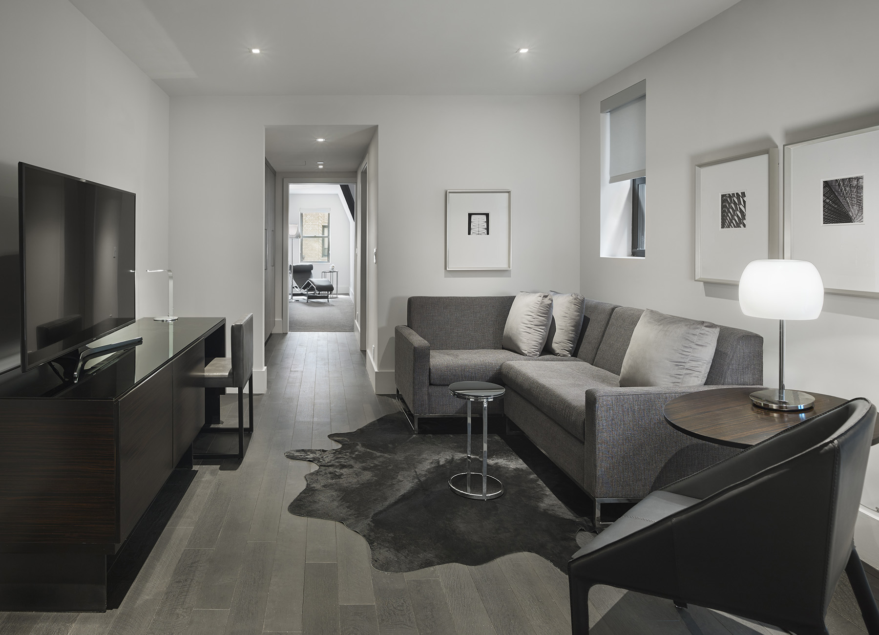 AKA Times Square penthouse lounge with modern black and gray furniture and tv