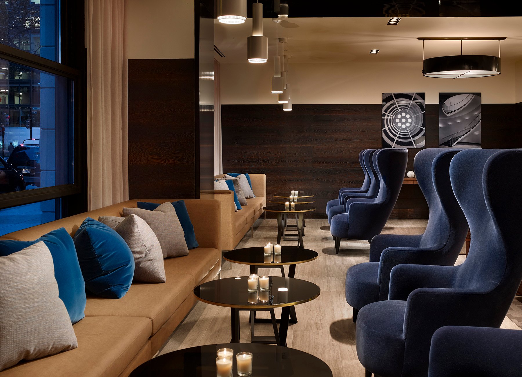Lobby with small tables and large blue chairs to relax in