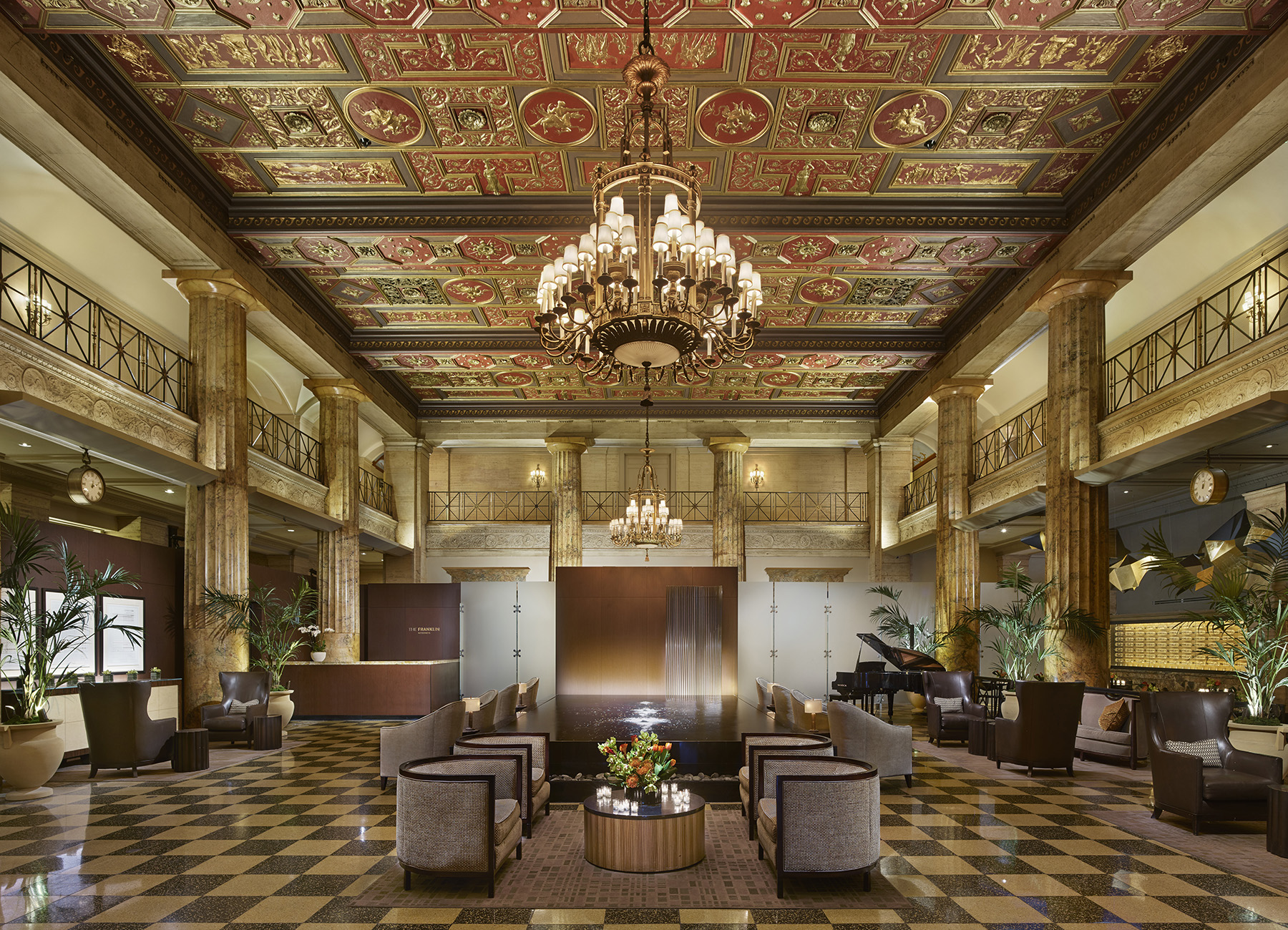 Lobby of historic Franklin Residences building with water feature and front desk