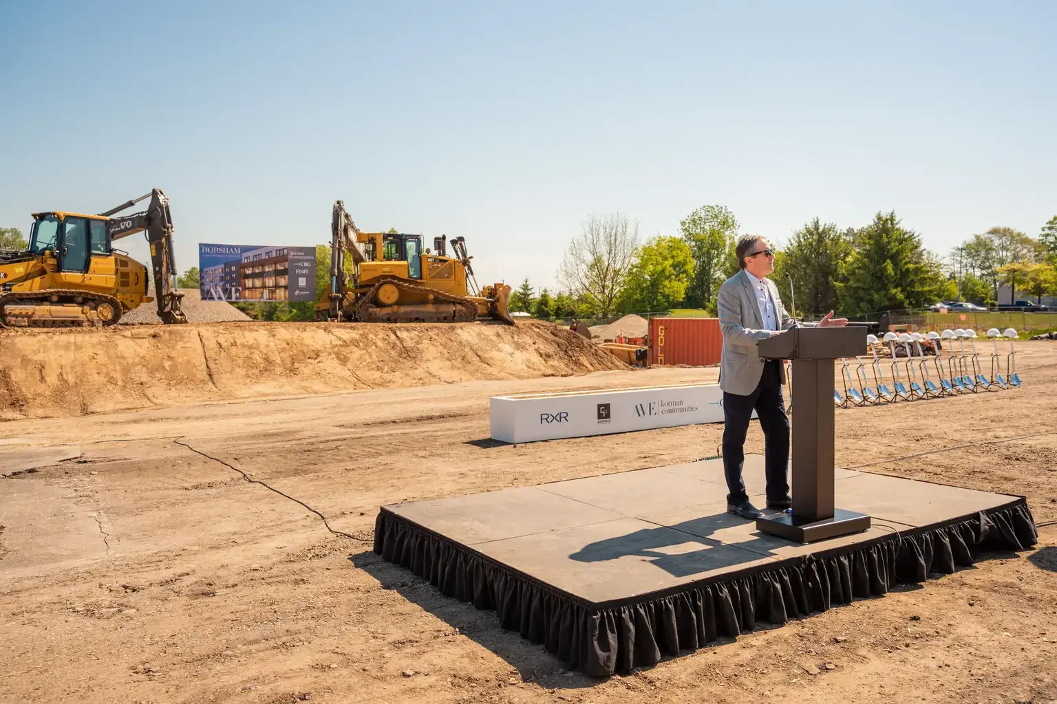 Speaker on stage at the AVE Horsham groundbreaking site