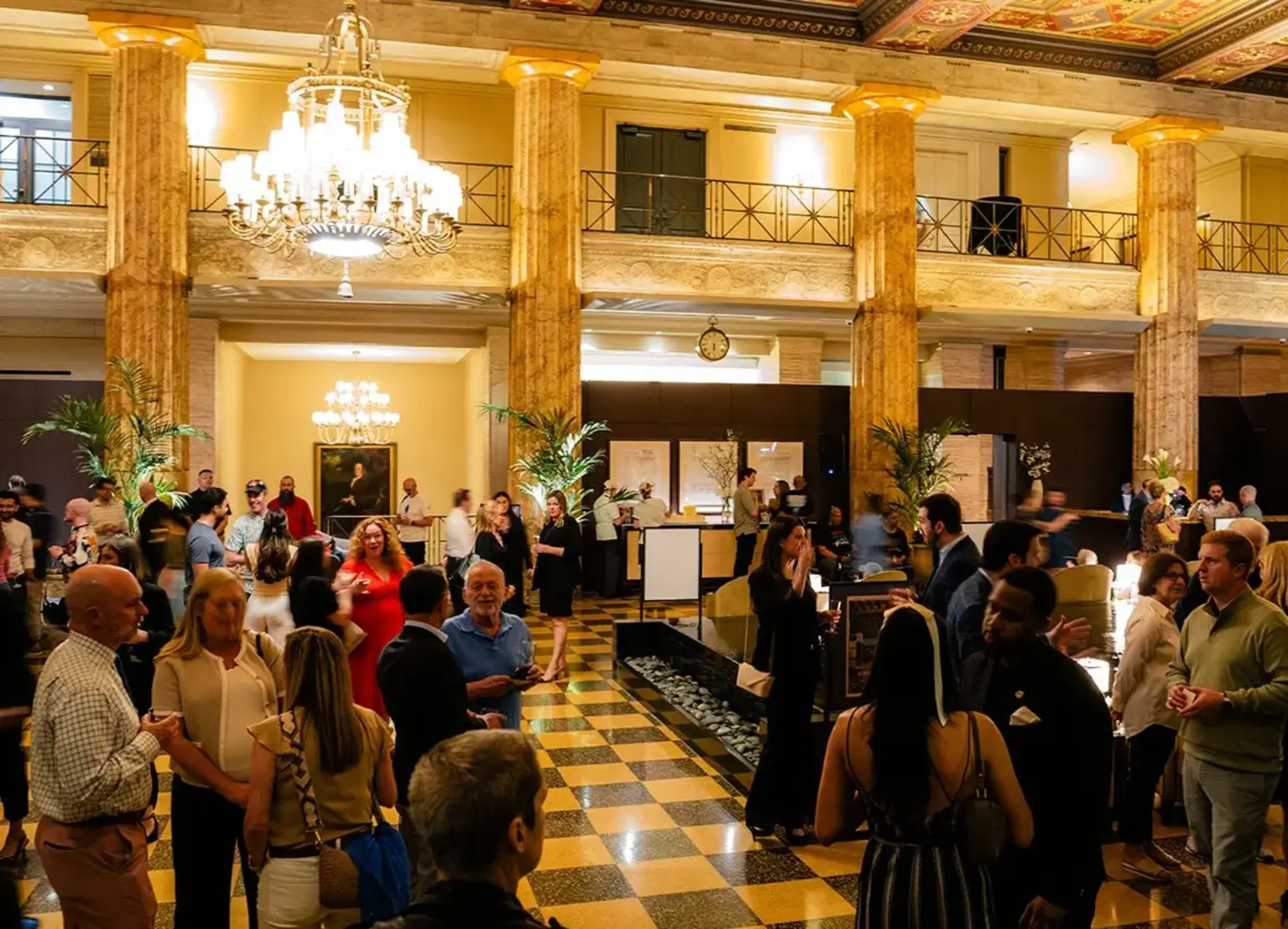 Residents, friends, neighbors, and guests celebrate in the restored lobby of the Franklin Residences