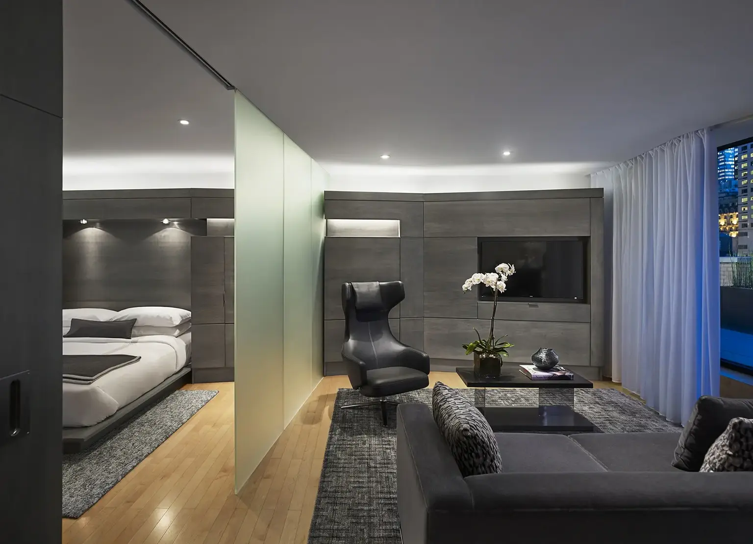 AKA Central Park furnished sky suite with modern bedroom furniture and living room space