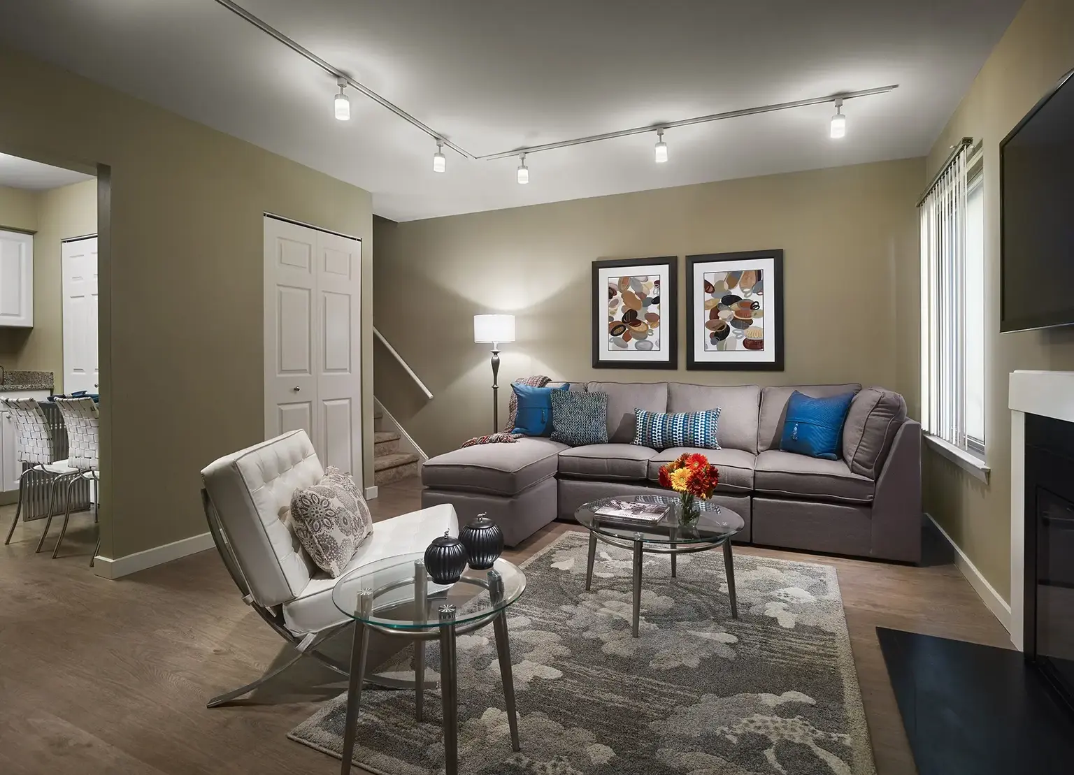 AVE Blue Bell Villas furnished apartment with gray couch and stairs to second level