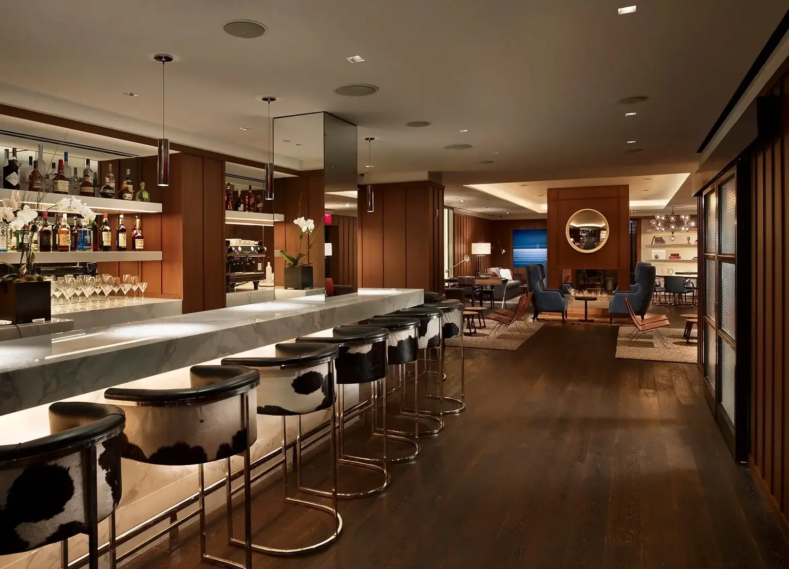 AKA Sutton Place Lounge with dim lighting and bottle displayed behind the bar