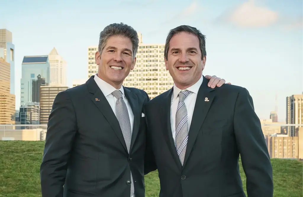 Larry and Brad Korman at CIRA rooftop with Philadelphia cityscape in the background