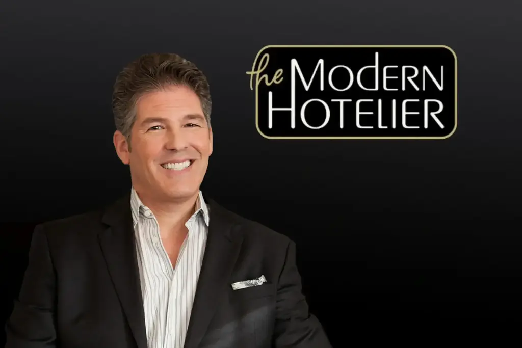 Larry Korman's portrait and The Modern Hotelier logo on black background