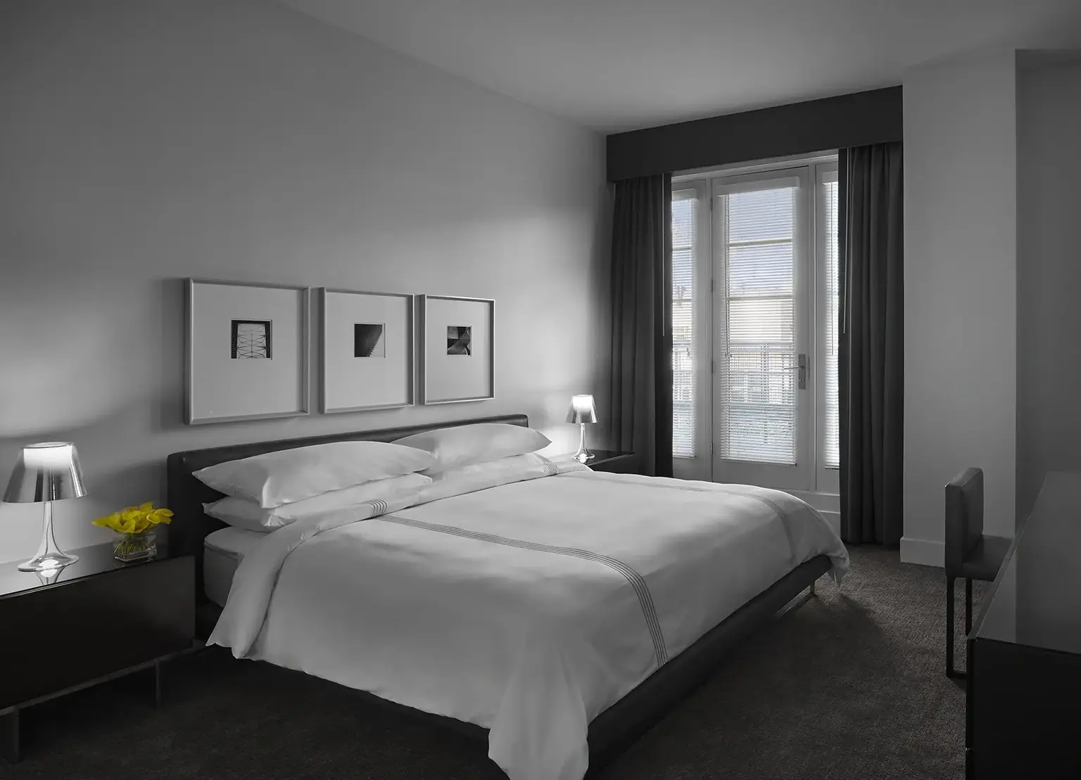 AKA White House apartment with large bedroom with white sheets on king bed
