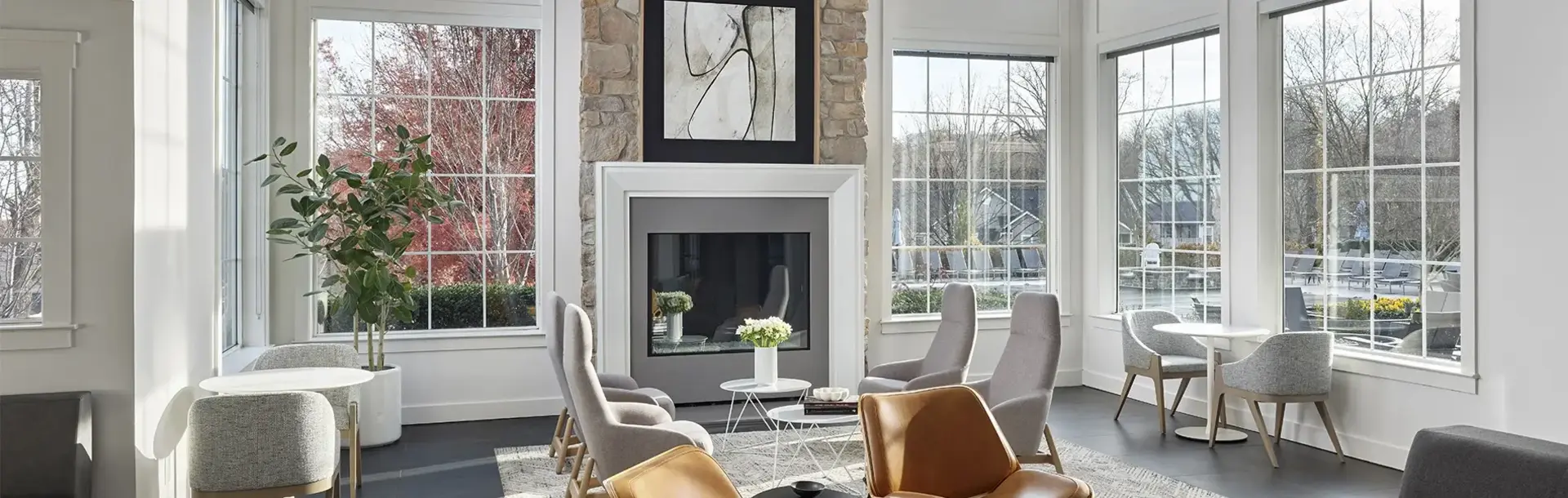 Large lounge with floor to ceiling windows, fireplace and seating at AV Malvern property