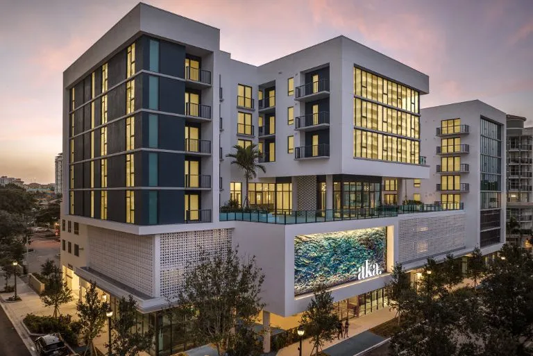 AKA West Palm apartment building façade at evening with pink skies