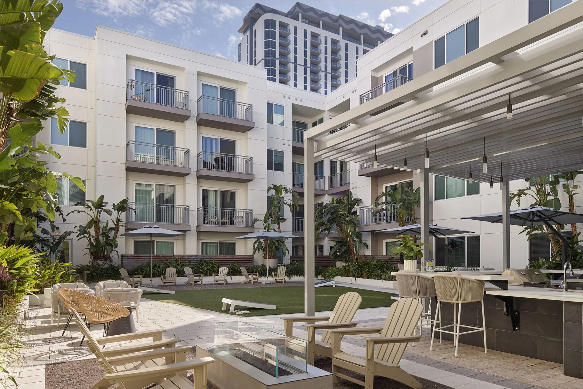 AVE Tampa Riverwalk inner courtyard with comfortable seating, outdoor fireplace and blue sky