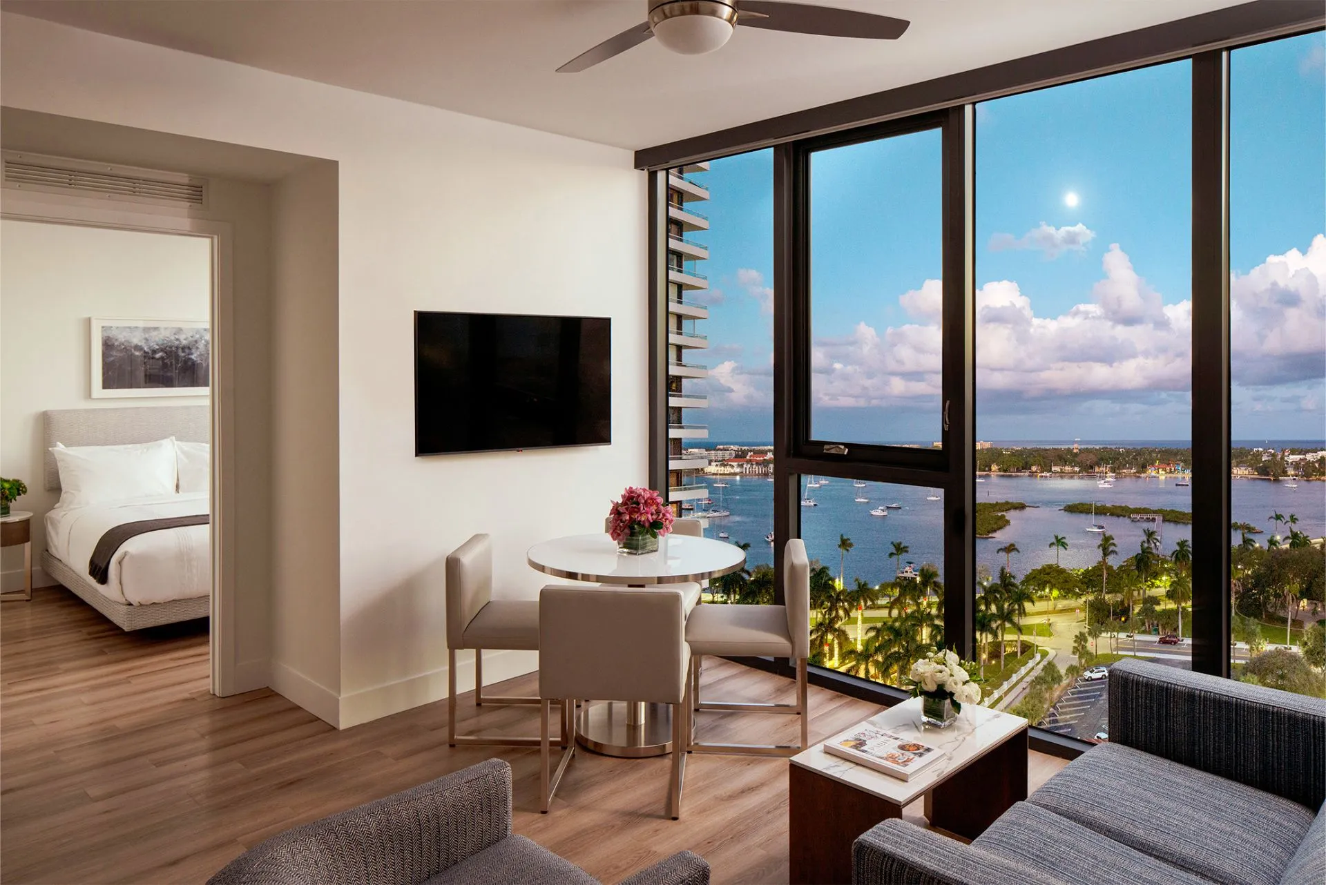 AKA West Palm living room with a large floor to ceiling window overlooking the bay