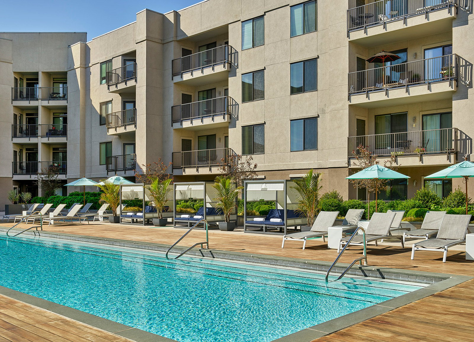 Pool in an outdoor courtyard with apartment building behind