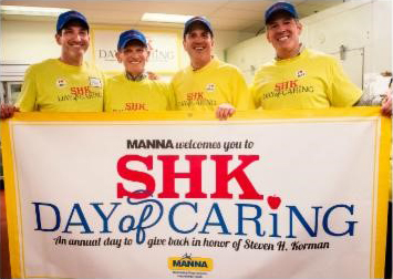 Kormans holding an SHK Day of Caring banner